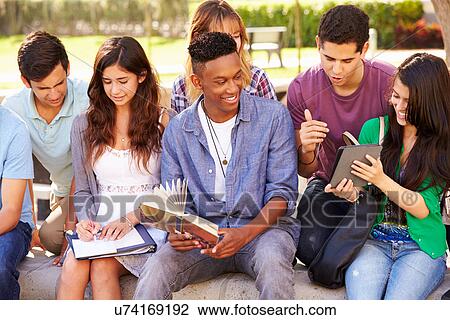 Stock Image - High School Students Collaborating On Project On Campus. Fotosearch