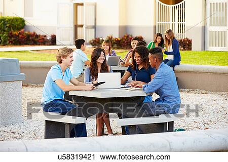 Stock Image - High School Students Hanging Out On Campus . Fotosearch
