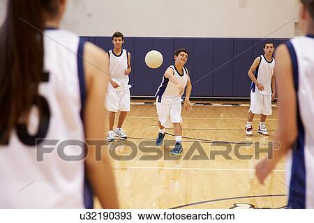 Stock Image - High School Students Playing Dodge Ball In Gym. Fotosearch