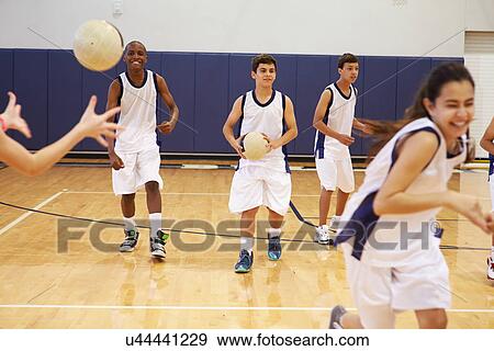 Stock Photo - High School Students Playing Dodge Ball In Gym. Fotosearch