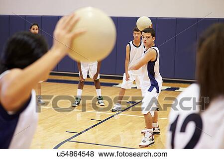 Stock Photo - High School Students Playing Dodge Ball In Gym. Fotosearch
