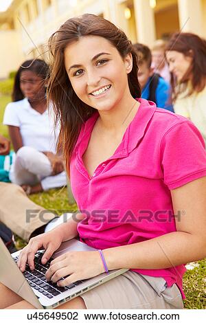 Stock Image - High School Students Studying Outdoors On Campus. Fotosearch