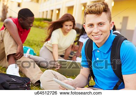 Stock Photograph - High School Students Studying Outdoors On Campus. Fotosearch