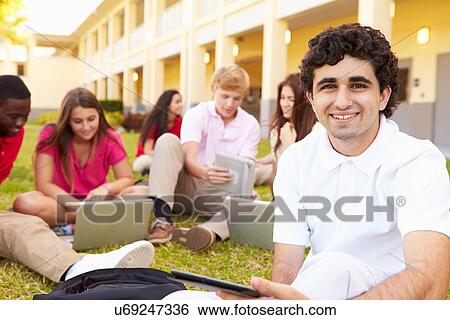 Stock Photograph - High School Students Studying Outdoors On Campus. Fotosearch