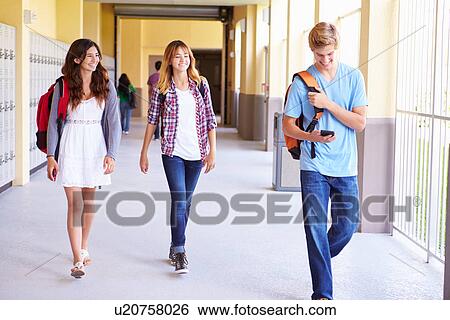 High School Students Walking In Hallway Using Mobile Phone View Large Photo Image Stock Photograph - High School Students Walking In Hallway Using Mobile Phone. Fotosearch