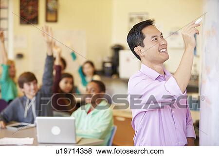 Stock Photo - High School Students With Teacher In Class Using Laptops. Fotosearch