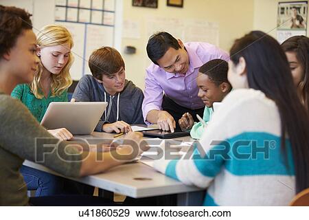 Stock Photo - High School Students With Teacher In Class Using Laptops. Fotosearch