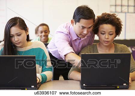 Stock Photo - High School Students With Teacher In Class Using Laptops. Fotosearch