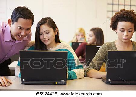 Stock Photography - High School Students With Teacher In Class Using Laptops. Fotosearch