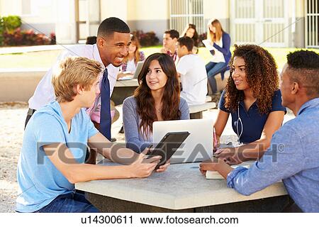 High School Students Working On Campus With Teacher View Large Photo Image Stock Image - High School Students Working On Campus With Teacher. Fotosearch
