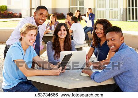 High School Students Working On Campus With Teacher View Large Photo Image Stock Photograph - High School Students Working On Campus With Teacher. Fotosearch