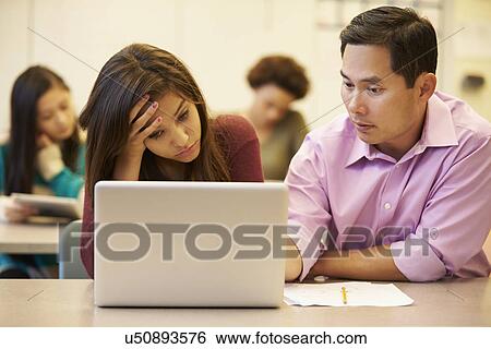 High School Teacher Helping Stressed Pupil In Class View Large Photo Image Stock Photograph - High School Teacher Helping Stressed Pupil In Class. Fotosearch