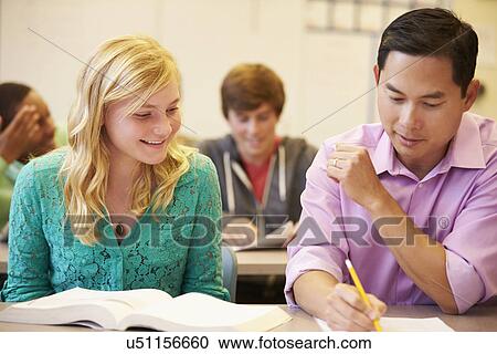 High School Teacher Helping Student With Written Work View Large Photo Image Stock Image - High School Teacher Helping Student With Written Work. Fotosearch