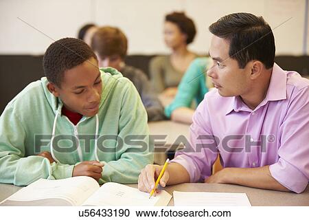 High School Teacher Helping Student With Written Work View Large Photo Image Stock Image - High School Teacher Helping Student With Written Work. Fotosearch