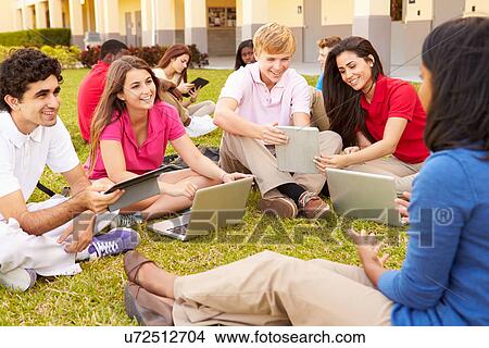 High School Teacher Sitting Outdoors With Students On Campus View Large Photo Image Picture - High School Teacher Sitting Outdoors With Students On Campus. Fotosearch