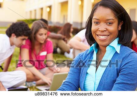 High School Teacher Sitting Outdoors With Students On Campus View Large Photo Image Stock Photograph - High School Teacher Sitting Outdoors With Students On Campus. Fotosearch