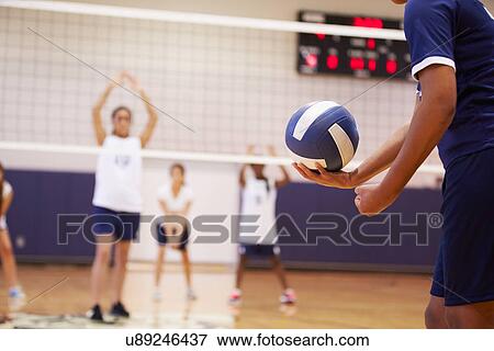 Stock Photo - High School Volleyball Match In Gymnasium. Fotosearch