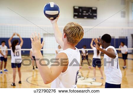 Stock Photograph - High School Volleyball Match In Gymnasium. Fotosearch