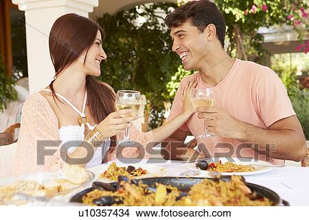 Hispanic Couple Enjoying Outdoor Meal At Home Together View Large Photo Image Picture - Hispanic Couple Enjoying Outdoor Meal At Home Together. Fotosearch
