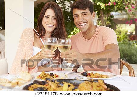 Hispanic Couple Enjoying Outdoor Meal At Home Together View Large Photo Image Stock Photo - Hispanic Couple Enjoying Outdoor Meal At Home Together. Fotosearch