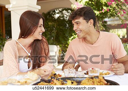 Stock Photo - Hispanic Couple Enjoying Outdoor Meal At Home Together. Fotosearch