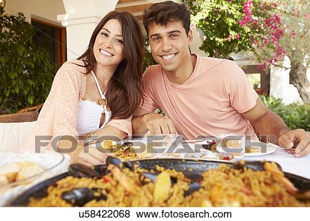 Hispanic Couple Enjoying Outdoor Meal At Home Together View Large Photo Image Stock Photo - Hispanic Couple Enjoying Outdoor Meal At Home Together. Fotosearch