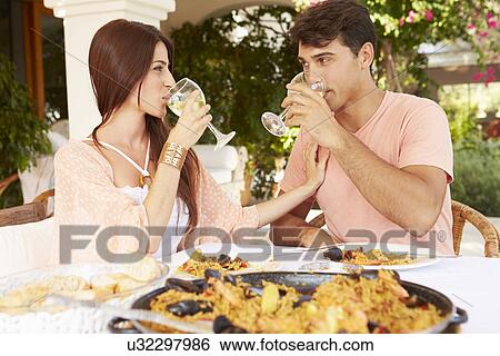Hispanic Couple Enjoying Outdoor Meal At Home Together View Large Photo Image Stock Photograph - Hispanic Couple Enjoying Outdoor Meal At Home Together. Fotosearch