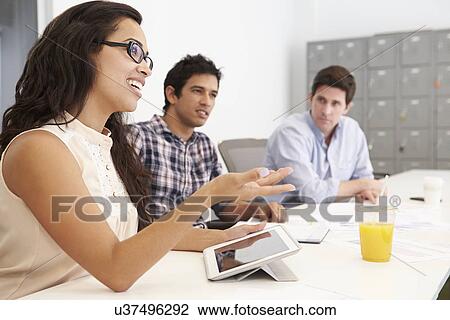 Stock Image - Hispanic Designers Meeting To Discuss New Ideas. Fotosearch