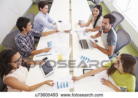 Stock Image - Hispanic Designers Meeting To Discuss New Ideas. Fotosearch