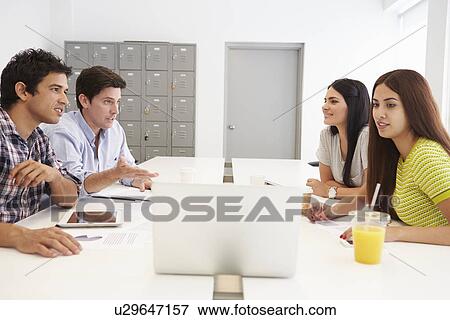Stock Photo - Hispanic Designers Meeting To Discuss New Ideas. Fotosearch