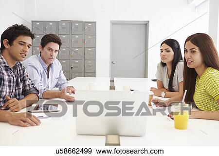 Stock Photo - Hispanic Designers Meeting To Discuss New Ideas. Fotosearch