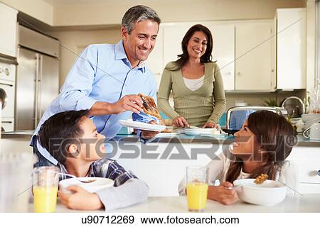 Hispanic Family Eating Breakfast At Home Together View Large Photo Image Stock Photo - Hispanic Family Eating Breakfast At Home Together. Fotosearch