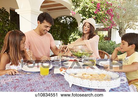 Hispanic Family Enjoying Outdoor Meal At Home Together View Large Photo Image Stock Image - Hispanic Family Enjoying Outdoor Meal At Home Together. Fotosearch