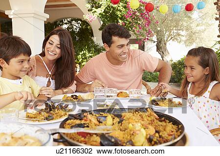 Hispanic Family Enjoying Outdoor Meal At Home Together View Large Photo Image Stock Image - Hispanic Family Enjoying Outdoor Meal At Home Together. Fotosearch