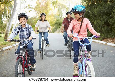 Picture - Hispanic Family On Cycle Ride In Countryside. Fotosearch