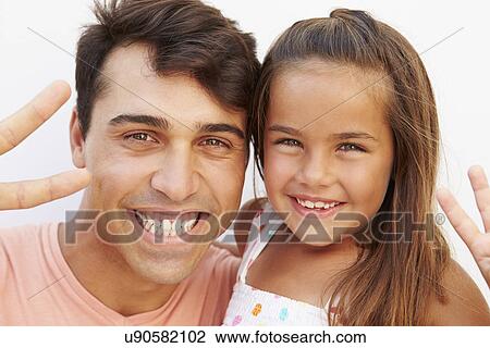Stock Image - Hispanic Father And Daughter Making Peace Sign. Fotosearch