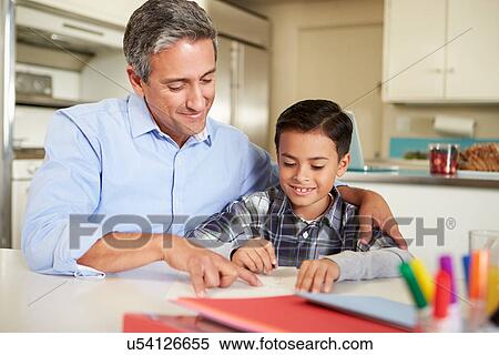 Hispanic Father Helping Son With Homework At Table View Large Photo Image Stock Photography - Hispanic Father Helping Son With Homework At Table. Fotosearch