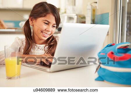Hispanic Girl Using Laptop To Do Homework At Table View Large Photo Image Stock Photo - Hispanic Girl Using Laptop To Do Homework At Table. Fotosearch