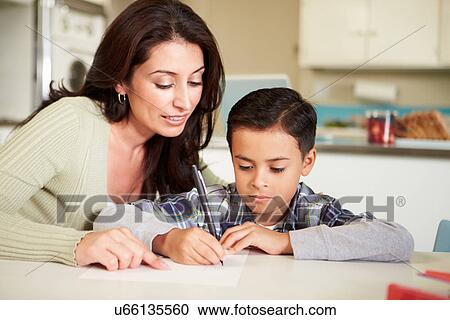 Hispanic Mother Helping Son With Homework At Table View Large Photo Image Stock Image - Hispanic Mother Helping Son With Homework At Table. Fotosearch