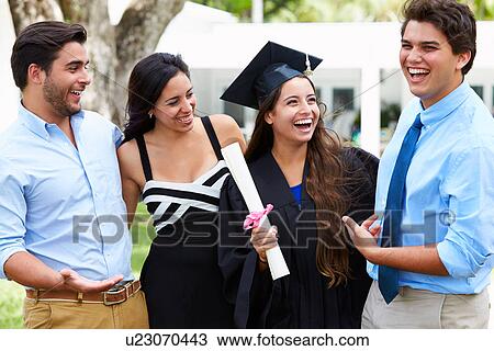 Stock Image - Hispanic Student And Family Celebrating Graduation. Fotosearch