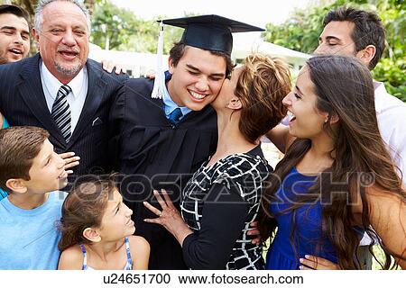 Stock Image - Hispanic Student And Family Celebrating Graduation. Fotosearch