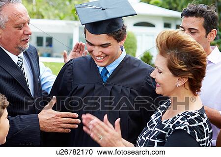 Stock Image - Hispanic Student And Family Celebrating Graduation. Fotosearch