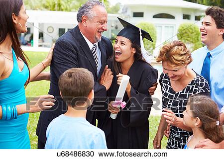 Stock Image - Hispanic Student And Family Celebrating Graduation. Fotosearch