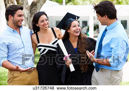 Stock Photo - Hispanic Student And Family Celebrating Graduation. Fotosearch