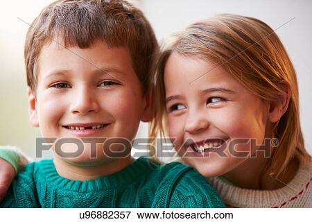 Stock Photo - Indoor Portrait Of Brother And Sister. Fotosearch