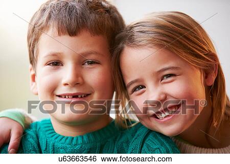 Stock Photograph - Indoor Portrait Of Brother And Sister. Fotosearch