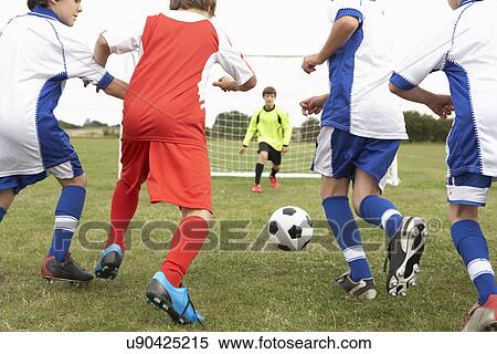 Junior 5 a side teams playing football View Large Photo Image Stock Photography - Junior 5 a side teams playing football. Fotosearch