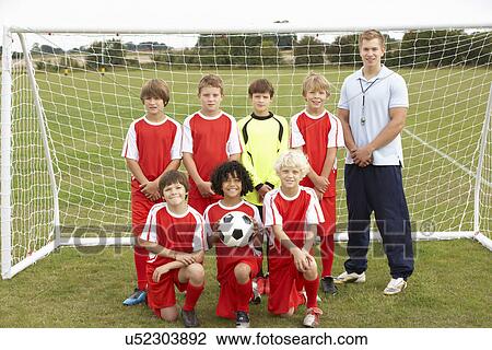 Stock Image - Junior football team and coach portrait. Fotosearch