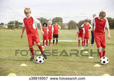Junior football team training with coach View Large Photo Image Stock Photo - Junior football team training with coach. Fotosearch