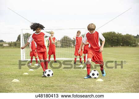 Stock Image - Junior soccer team in training. Fotosearch